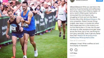 Runner carries fellow racer to the finish line