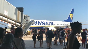 Ryanair passengers filmed fleeing plane after cell phone bursts into flames