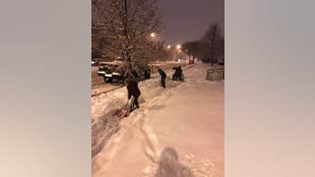 Photo of boys helping man in wheelchair shovel snow goes viral