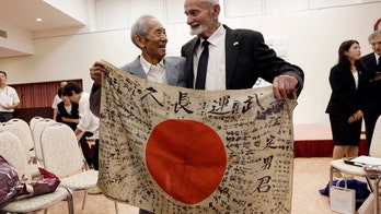 Japanese siblings accept WWII soldier's flag from US veteran
