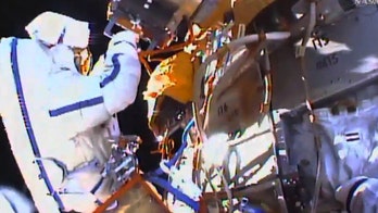 Spacewalkers collect experiment, toss flash drive overboard