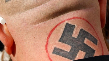 Tattoo artist covers up racist, gang symbols for free