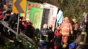 Tour bus flips over on Taiwan highway, killing 32 people