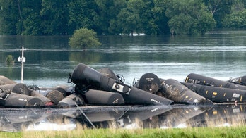 Crude oil spills into Iowa river after freight train derailment
