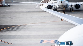 Airport worker flips cone onto stack then celebrates with hilarious victory dance