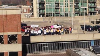 Woman battling leukemia surprised with flash mob of supporters outside hospital room window