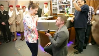 Man proposes to girlfriend at 35,000 feet while crew serenade the happy couple