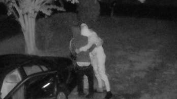 Surveillance video catches thieves hugging excitedly after finding money in an unlocked car