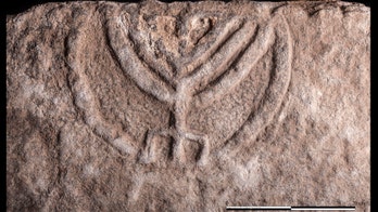 Ancient tomb door with stunning menorah carving revealed in Israel