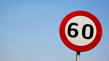 Russian road safety experts employ topless women to hold speed limit signs