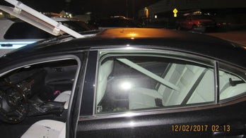Police: Woman drove with transit sign sticking out of car