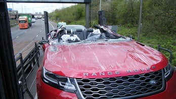 Range Rover's roof ripped off when transport truck it's on misjudges bridge