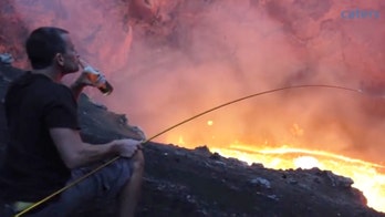 Extreme campfire cooking: Man toasts marshmallow over volcano