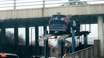 Transport truck slams SUV on top of it into bridge