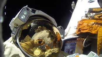 Russian astronauts spacewalk to complete camera hookup, cables thwarted Dec. attempt