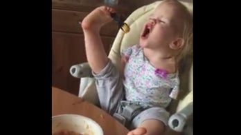 Toddler born with no arms teaches herself to eat with feet