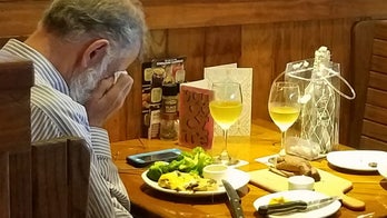 Heartbreaking photo appears to show man eating across from wife's ashes on Valentine's Day