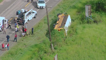Driver, 14 students hurt after school bus flips near Houston