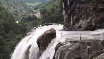 The world's wildest road goes through a waterfall in the Himalayas