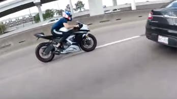 Motorcycle rider pulls off incredible 'wobble' save after hitting a pothole at 130 mph