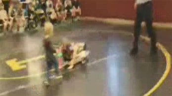 Toddler interrupts wrestling match to 'save' older sister