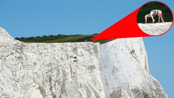 Woman seen doing yoga on edge of crumbling cliff