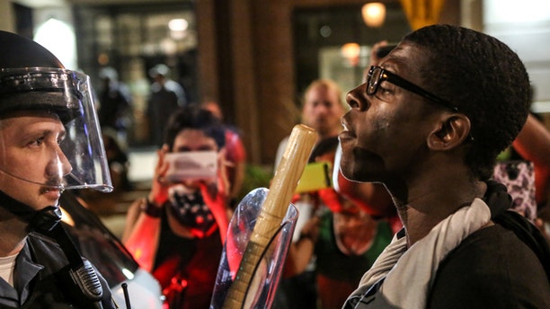 A protester confront police during the second night of demonstrations. Cops may soon be limited in what actions they can take against protesters.