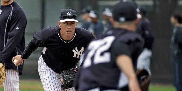 New York Yankees' Alex Rodriguez, center, flips the ball to pitcher Danny Burawa, right, as Mark Teixeira, left, looks on during workouts Friday, Feb. 27, 2015, in Tampa, Fla. Rodriguez was practicing at first base for the first time. (AP Photo/Chris O'Meara)