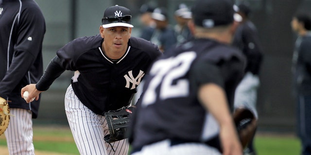 New York Yankees' Alex Rodriguez, center, flips the ball to pitcher Danny Burawa, right, as Mark Teixeira, left, looks on during workouts Friday, Feb. 27, 2015, in Tampa, Fla. Rodriguez was practicing at first base for the first time. (AP Photo/Chris O'Meara)