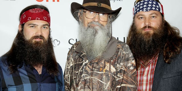 This image released by Starpix shows TV personalities,from left, Jep Robertson, Si Robertson, and Willie Robertson, from the A&E series "Duck Dynasty," at the Sherri Hill Fashion Show, Monday, Sept. 9, 2013, in New York. The Robertsons attended to support Willie's daughter Sadie Robertson who modeled several outfits for the show. (AP Photo/Starpix, Marion Curtis)