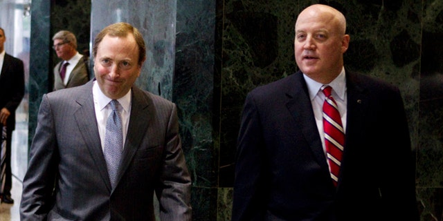 Aug. 14, 2012: This file photo shows NHL commissioner Gary Bettman, left, and Bill Daly, deputy commissioner and chief legal officer, following collective bargaining talks in Toronto.