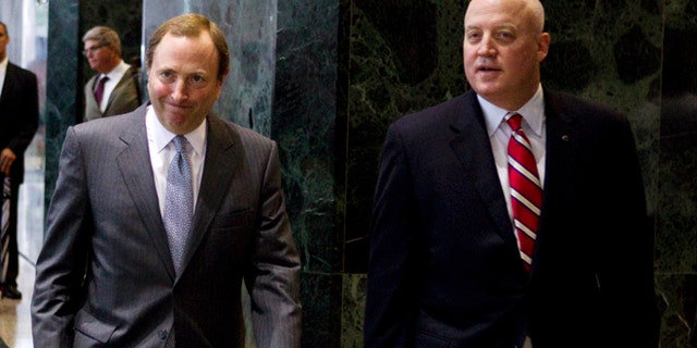 Aug. 14, 2012: This file photo shows NHL commissioner Gary Bettman, left, and Bill Daly, deputy commissioner and chief legal officer, following collective bargaining talks in Toronto.