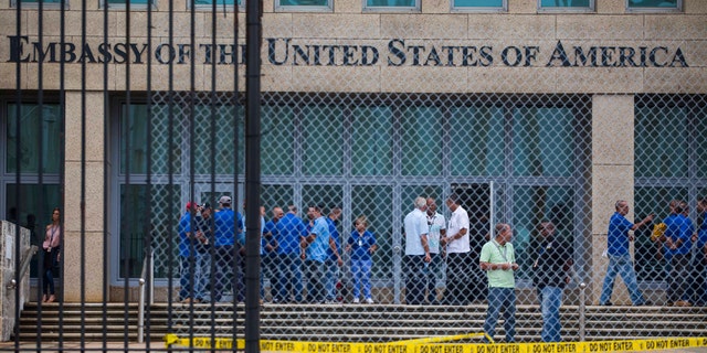 In a Friday, Sept. 29, 2017 file photo, staff stand within the United States embassy facility in Havana, Cuba.