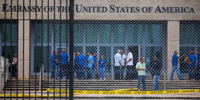 In a Friday, Sept. 29, 2017 file photo, staff stand within the United States embassy facility in Havana, Cuba.