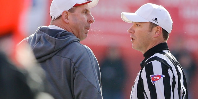 Nebraska head coach Bo Pelini, left, protests a pass interference call with referee Alex Kemp, right, in the third quarter of an NCAA college football game against Iowa in Lincoln, Neb., Friday, Nov. 29, 2013. Iowa won 38-17. (AP Photo/Nati Harnik)