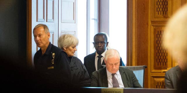 This is Sept. 16, 2015 file picture shows Claver Berinkindi, second from right a Swedish citizen originally from Rwanda. Claver Berinkindi on Monday May 16, 2016 was found guilty of genocide and gross violation of international law. The Stockholm district court said the 61-year-old was an informal low-level Hutu leader who took part in massacres of civilians in Muyira and Butare in southern Rwanda.. (Jessica Gow/TT via AP) SWEDEN OUT