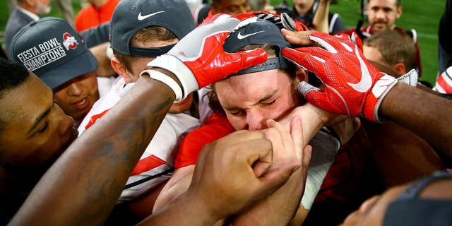 Jan 1, 2016; Glendale, AZ, USA; Ohio State Buckeyes defensive lineman Joey Bosa reacts as he celebrates with teammates on the field following the game against the Notre Dame Fighting Irish during the 2016 Fiesta Bowl at University of Phoenix Stadium. The Buckeyes defeated the Fighting Irish 44-28. Bosa was ejected in the first quarter for targeting. Mandatory Credit: Mark J. Rebilas-USA TODAY Sports