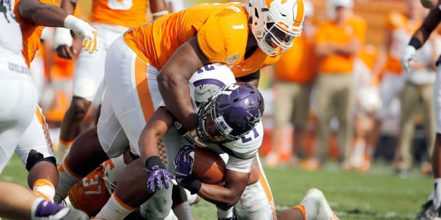 Jan 1, 2016; Tampa, FL, USA; Tennessee Volunteers defensive lineman Kahlil McKenzie (1) tackles Northwestern Wildcats running back Justin Jackson (21) during the first half in the 2016 Outback Bowl at Raymond James Stadium. Mandatory Credit: Kim Klement-USA TODAY Sports