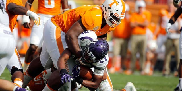 Jan 1, 2016; Tampa, FL, USA; Tennessee Volunteers defensive lineman Kahlil McKenzie (1) tackles Northwestern Wildcats running back Justin Jackson (21) during the first half in the 2016 Outback Bowl at Raymond James Stadium. Mandatory Credit: Kim Klement-USA TODAY Sports