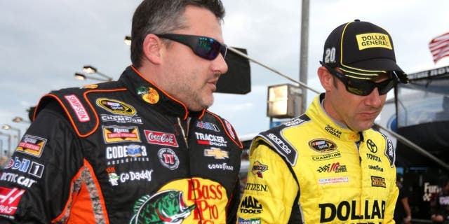 HOMESTEAD, FL - NOVEMBER 22: Tony Stewart, driver of the #14 Bass Pro Shops/Mobil 1 Chevrolet, talks to Matt Kenseth, driver of the #20 Dollar General Toyota, during the NASCAR Sprint Cup Series Ford EcoBoost 400 at Homestead-Miami Speedway on November 22, 2015 in Homestead, Florida. (Photo by Chris Graythen/Getty Images)
