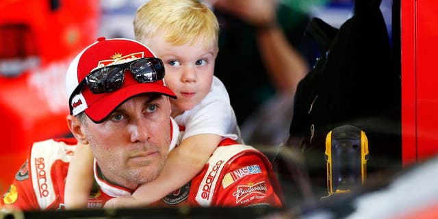 HOMESTEAD, FL - NOVEMBER 20: Kevin Harvick, driver of the #4 Budweiser/Jimmy John's Chevrolet, spends time with his son Keelan Harvick in the garage area during practice for the NASCAR Sprint Cup Series Ford EcoBoost 400 at Homestead-Miami Speedway on November 20, 2015 in Homestead, Florida. (Photo by Jonathan Ferrey/NASCAR via Getty Images)