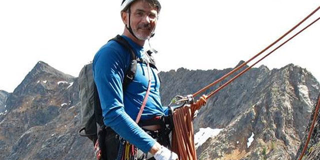 Doug Walker is pictured mountain climbing.