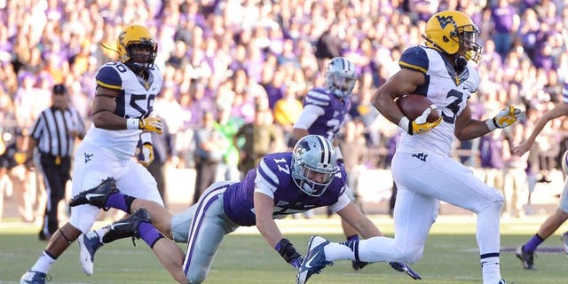 Oct 26, 2013; Manhattan, KS, USA; Kansas State Wildcats defensive back Weston Hiebert (17) misses a tackle on West Virginia Mountaineers running back Charles Sims (3) during the second half at Bill Snyder Family Stadium. The Wildcats defeat the Mountaineers 35-12. Mandatory Credit: Jasen Vinlove-USA TODAY Sports