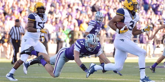 Oct 26, 2013; Manhattan, KS, USA; Kansas State Wildcats defensive back Weston Hiebert (17) misses a tackle on West Virginia Mountaineers running back Charles Sims (3) during the second half at Bill Snyder Family Stadium. The Wildcats defeat the Mountaineers 35-12. Mandatory Credit: Jasen Vinlove-USA TODAY Sports