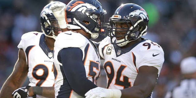 OAKLAND, CA - NOVEMBER 09: DeMarcus Ware #94 of the Denver Broncos celebrates with teammate Von Miller #58 in the third quarter against the Oakland Raiders at O.co Coliseum on November 9, 2014 in Oakland, California. (Photo by Ezra Shaw/Getty Images)