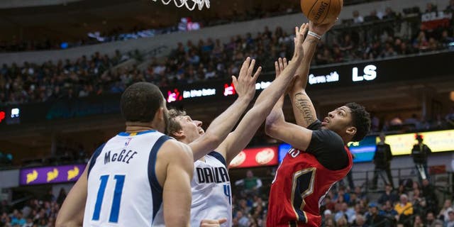 Jan 2, 2016; Dallas, TX, USA; New Orleans Pelicans forward Anthony Davis (23) shoots over Dallas Mavericks forward Dirk Nowitzki (41) and center JaVale McGee (11) during the second half at the American Airlines Center. The Pelicans defeat the Mavericks 105-98. Mandatory Credit: Jerome Miron-USA TODAY Sports