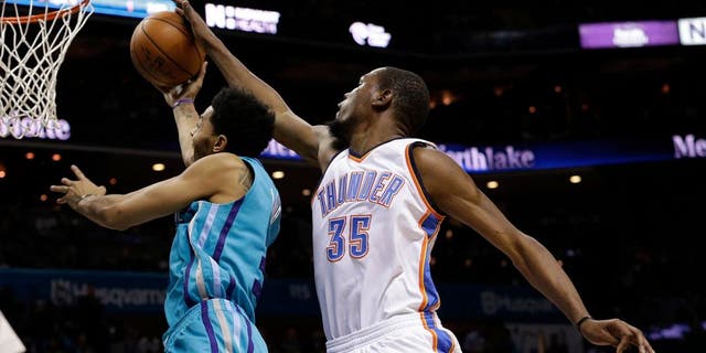 Jan 2, 2016; Charlotte, NC, USA; Oklahoma City Thunder forward Kevin Durant (35) blocks the shot of Charlotte Hornets guard Jeremy Lamb (3) from behind in the second half at Time Warner Cable Arena. The Thunder defeated the Hornets 109-90. Mandatory Credit: Jeremy Brevard-USA TODAY Sports