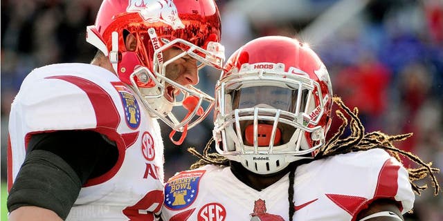 Jan 2, 2016; Memphis, TN, USA; Arkansas Razorbacks running back Alex Collins (3) and Arkansas Razorbacks tight end Jeremy Sprinkle (83) celebrate a touchdown during the first half against the Kansas State Wildcats at Liberty Bowl. Mandatory Credit: Justin Ford-USA TODAY Sports