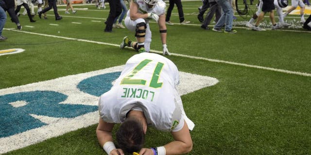 Jan 2, 2016; San Antonio, TX, USA; Oregon Ducks quarterback Jeff Lockie (17) reacts after the 2016 Alamo Bowl against the TCU Horned Frogs at Alamodome. TCU defeated Oregon 47-41 in triple overtime. Mandatory Credit: Kirby Lee-USA TODAY Sports