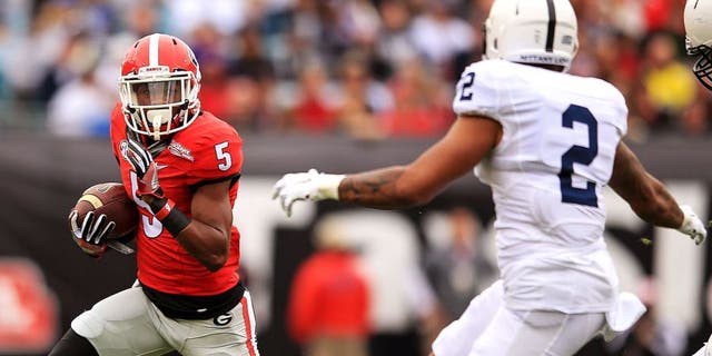 JACKSONVILLE, FL - JANUARY 02: Terry Godwin #5 of the Georgia Bulldogs carries as Marcus Allen #2 of the Penn State Nittany Lions defends during the first half of the TaxSlayer Bowl game at EverBank Field between the Georgia Bulldogs and the Penn State Nittany Lions on January 2, 2016 in Jacksonville, Florida. (Photo by Rob Foldy/Getty Images)